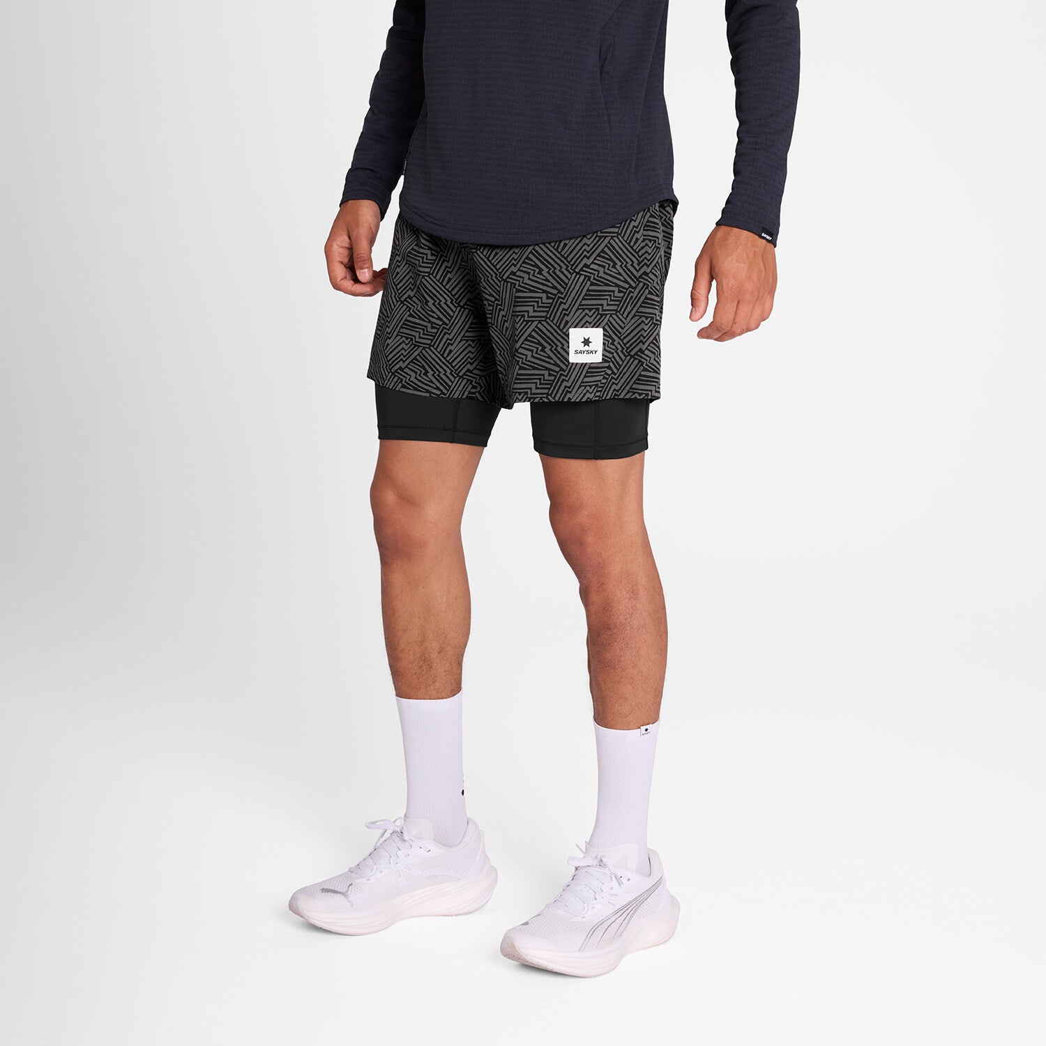 man wearing SAYSKY reflective 2in1 Pace running shorts 