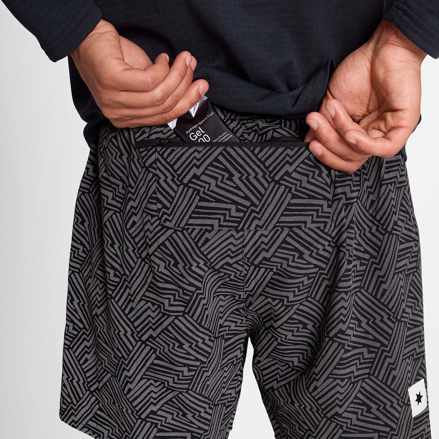 SAYSKY reflective 2in1 Pace running shorts showing maurten gel fitting inside back zip pocket