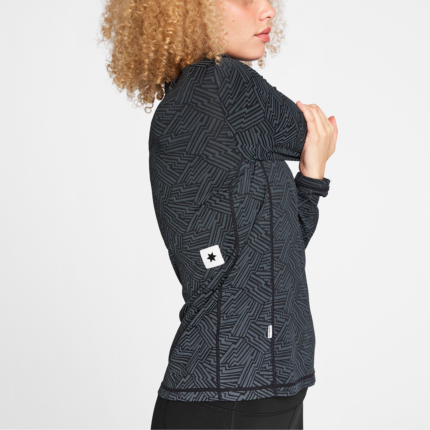 Woman wearing SAYSKY Reflective Pace Half Zip Long Sleeve Run Top