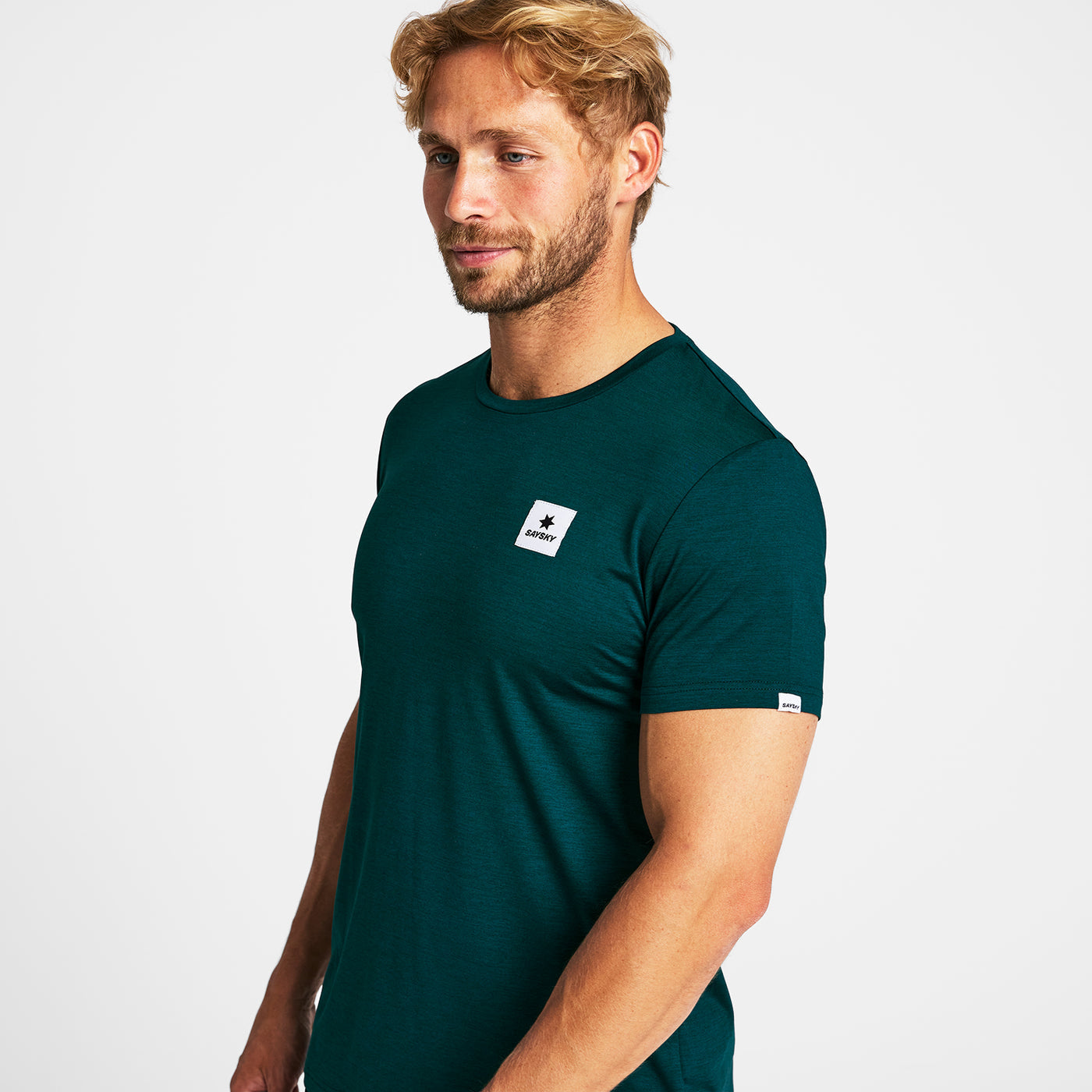 Man wearing a green SAYSKY run t-shirt with logo