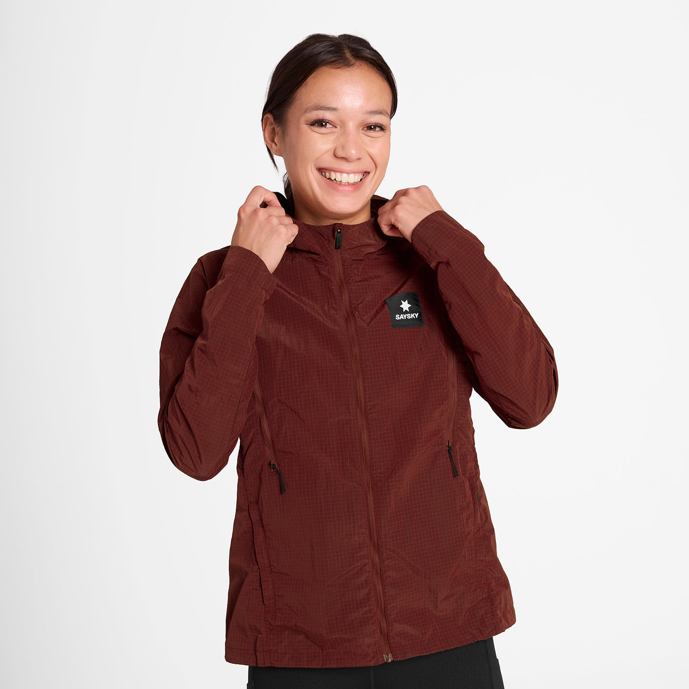Woman wearing SAYSKY Clean Pace Shield Running Jacket in red colour