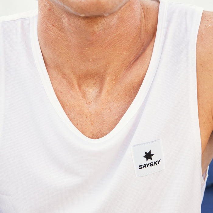 SAYSKY singlet tank top for men, breathable and anti-cling running top, white colour with logo detail, close up shot of SAYSKY logo