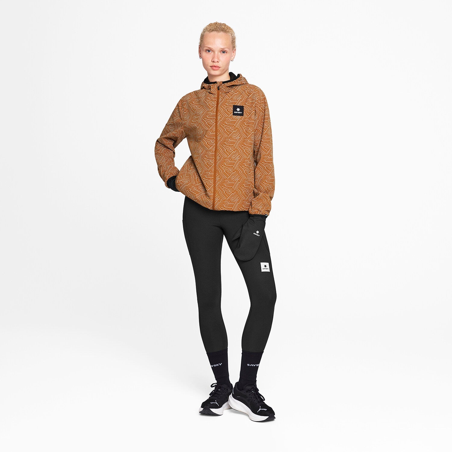 Woman wearing SAYSKY reflective blaze jacket in orange colour