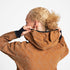 Woman wearing SAYSKY reflective blaze jacket in orange colour, showing close up of hood at back