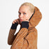 Woman wearing SAYSKY reflective blaze jacket in orange colour, showing hood and long cuffs