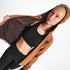 Woman wearing SAYSKY reflective blaze jacket in orange colour, showing inside lining
