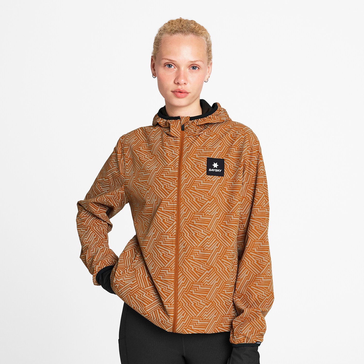 Woman wearing SAYSKY reflective blaze jacket in orange colour