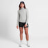 saysky womens pace 1/2 zip long sleeve, lightweight breathable half zip top for running, light grey colour, full body shot of woman wearing grey saysky top and black shorts