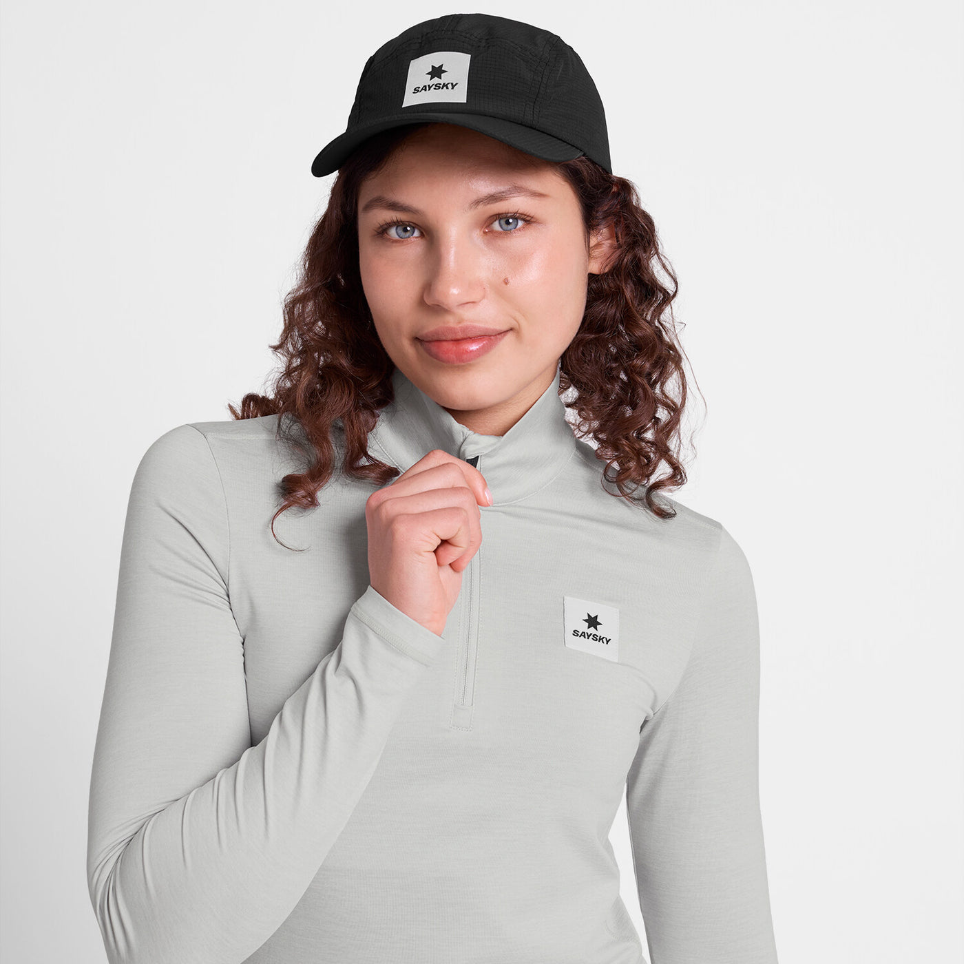 saysky womens pace 1/2 zip long sleeve, lightweight breathable half zip top for running, light grey colour, close up view of woman wearing grey saysky top