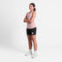 SAYSKY reactive flow pink singlet tank top for women, ultra-light, race tank, full body view of women wearing SAYSKY tank with black shorts