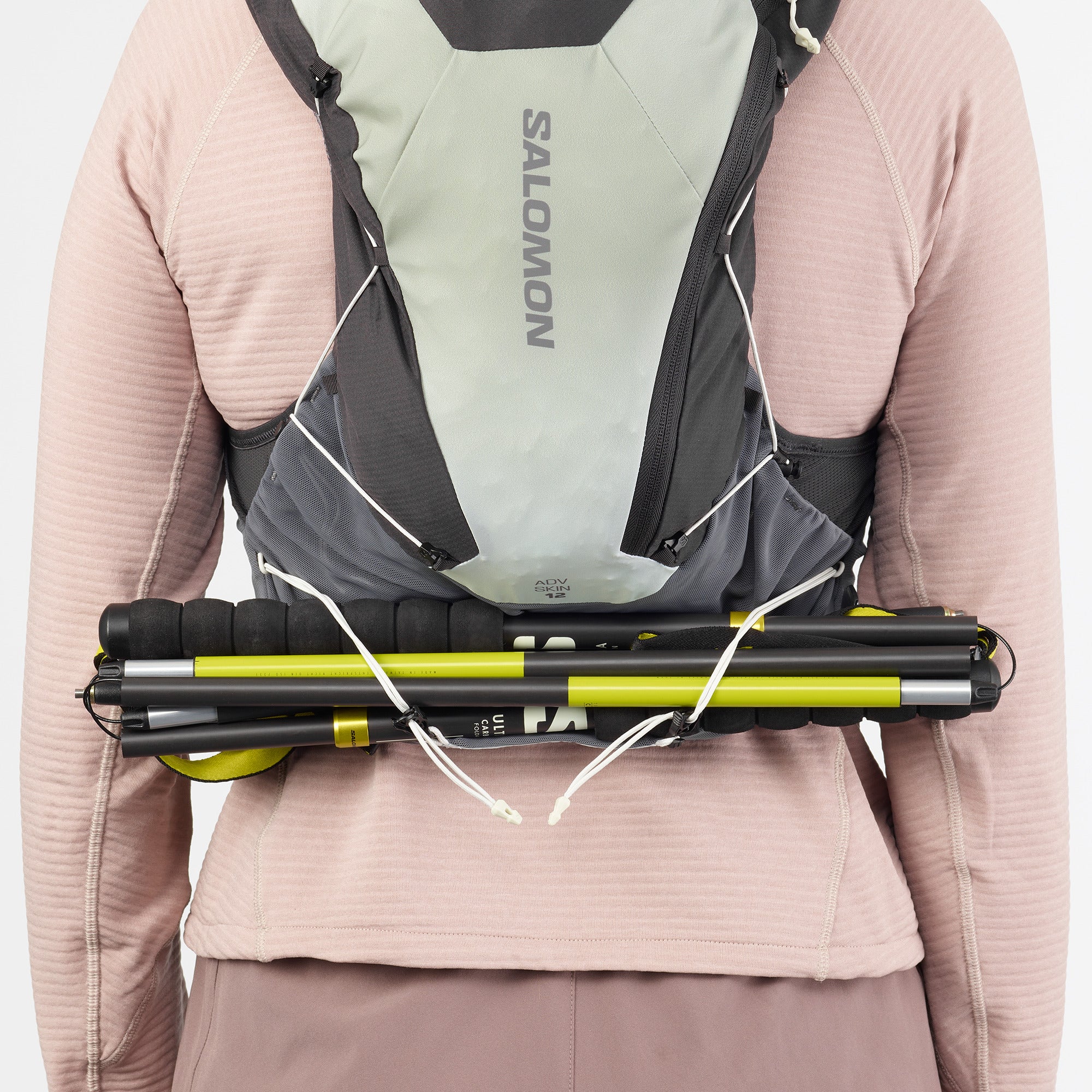 Salomon ADV Skin 12, 12 liter running vest, dark grey colour with dark green accents, back of vest with poles attached behind