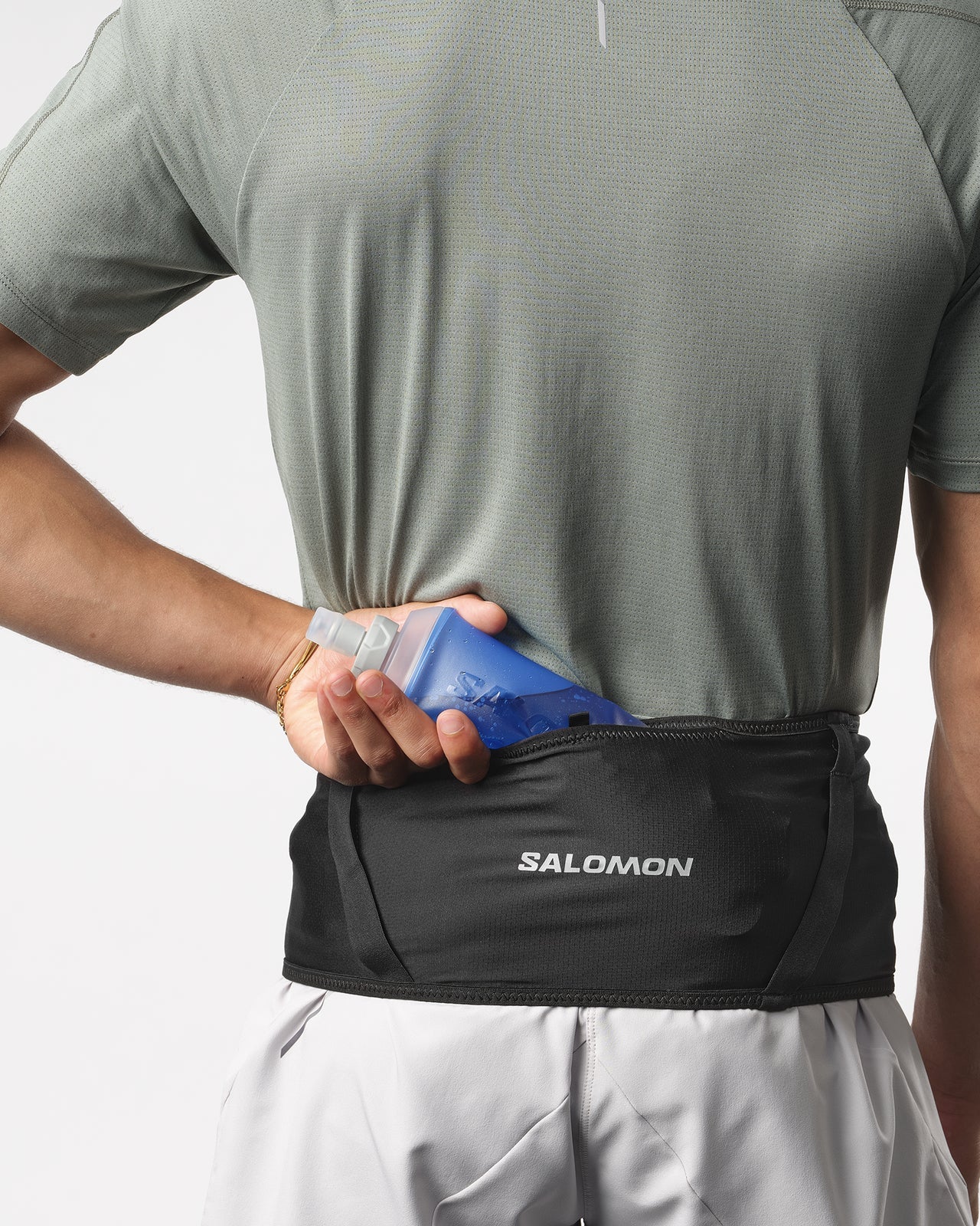 Man wearing Salomon High Point running belt that holds water flasks and other essentials