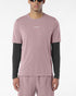 Man wearing salomon shakeout core tee in a pink colour, reflective logo on front