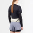 salomon pulse belt, trail running belt with zipper pocket, cream white colour with grey details, woman wearing packed belt from the back