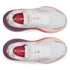 Pair of white running shoes with pink and purple accents top overview