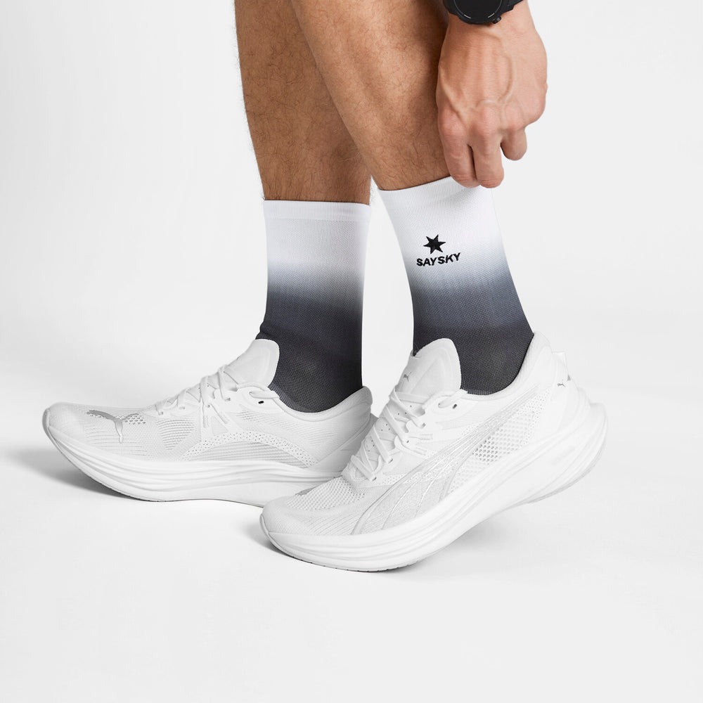 saysky combat socks, black and white gradient socks above the ankle on model with white shoes