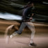 Person running on a track with reflective saysky socks and tights