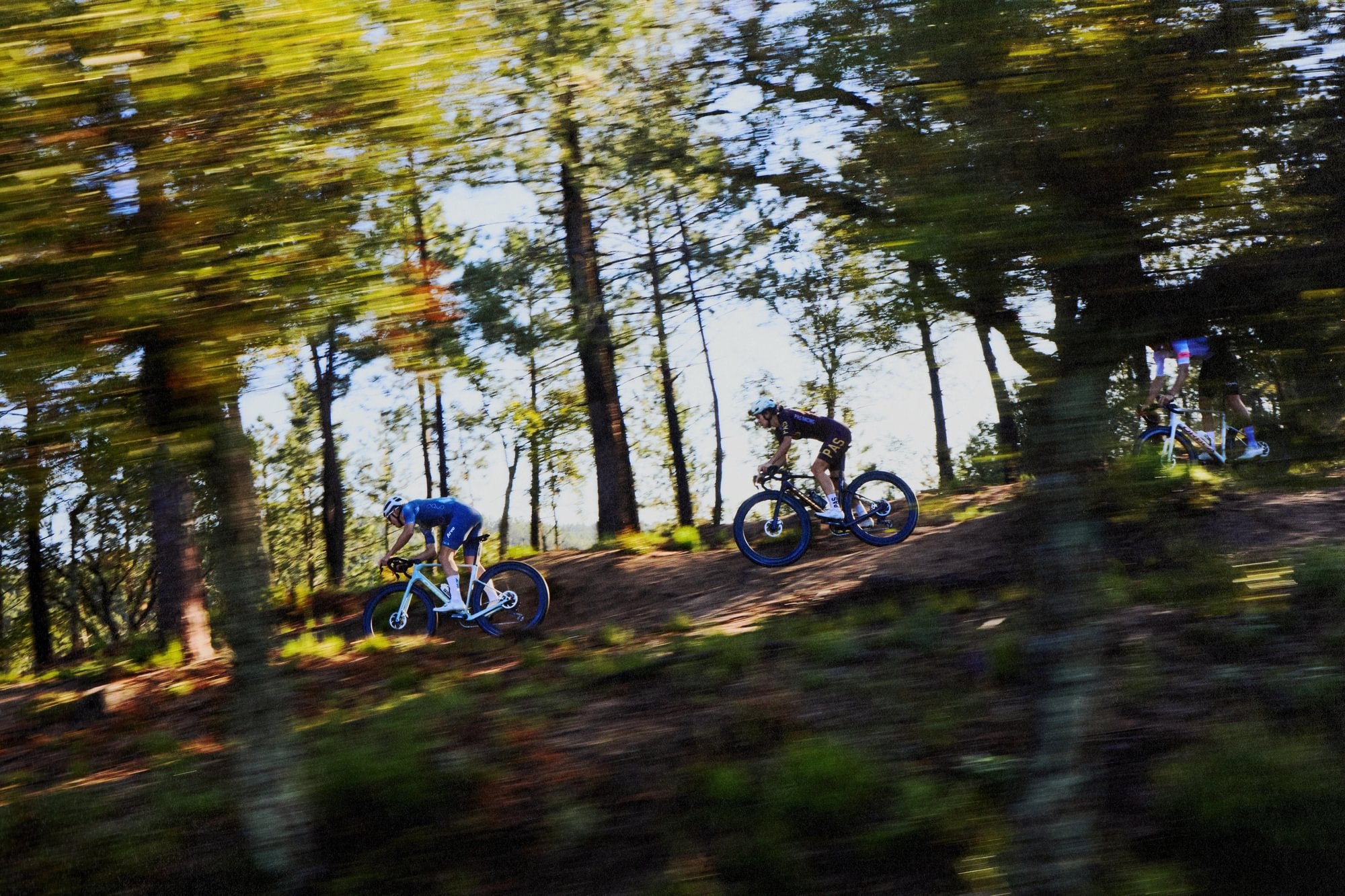 guys gravel racing in forest on orbea terra race bikes