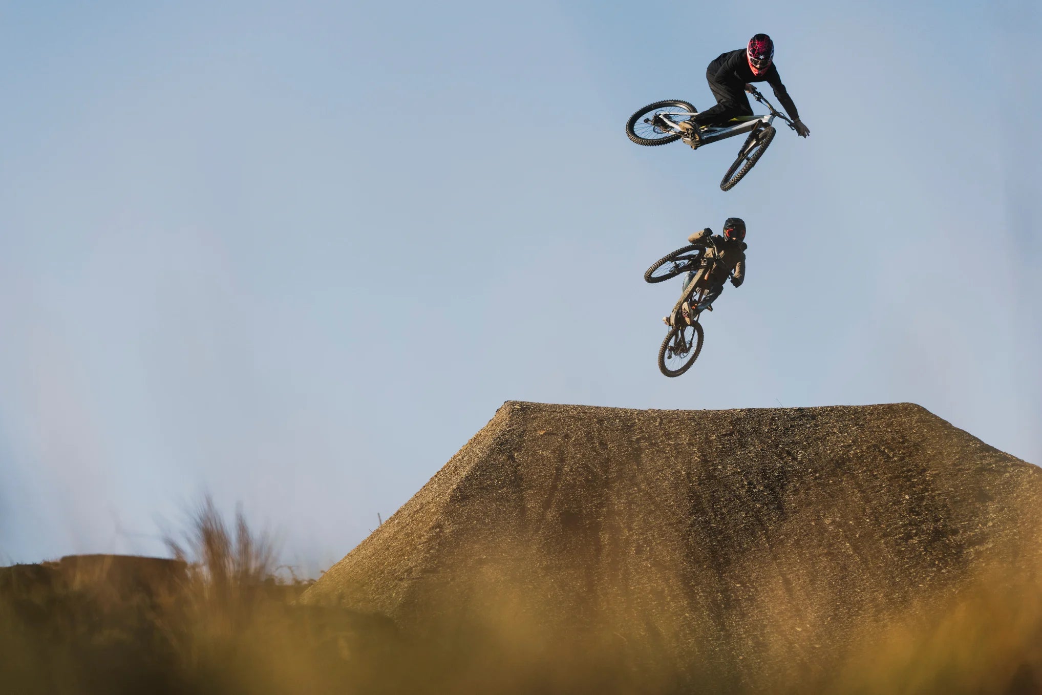 two guys catching air on orbea mountain bikes
