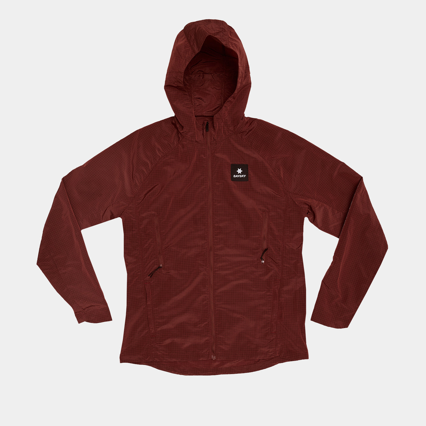 Woman wearing SAYSKY Clean Pace Shield Running Jacket in red colour