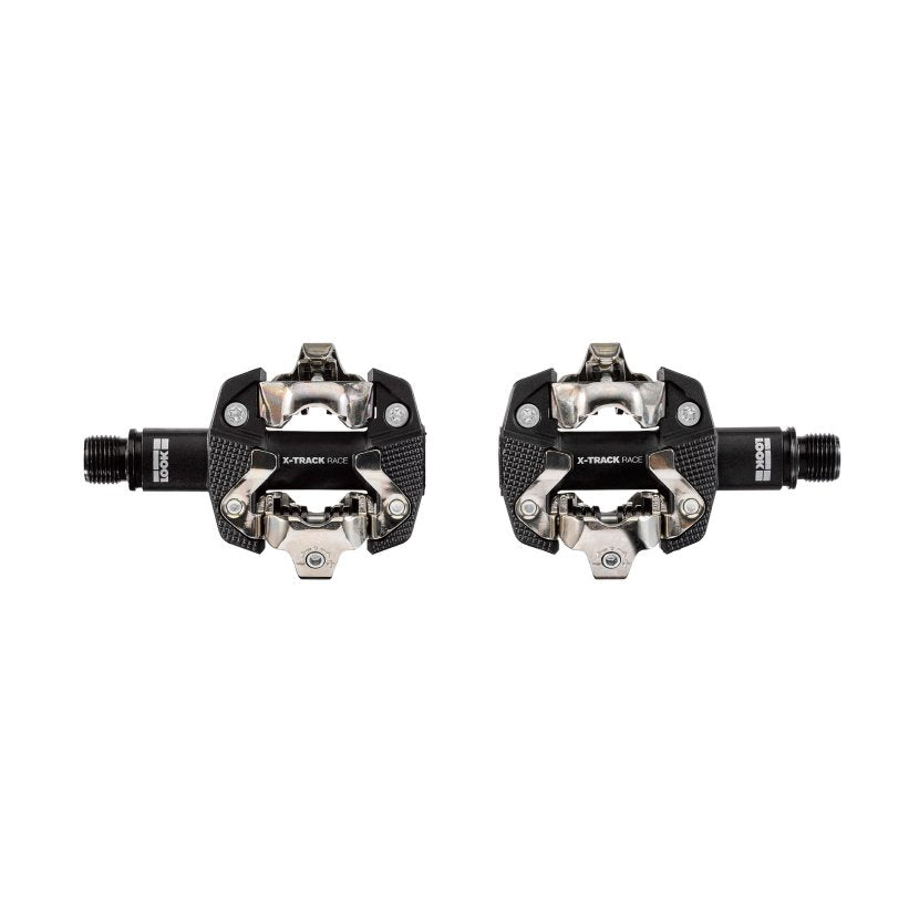 x track race pedal box, clipless mtb racing pedals, two pedals laid out flat