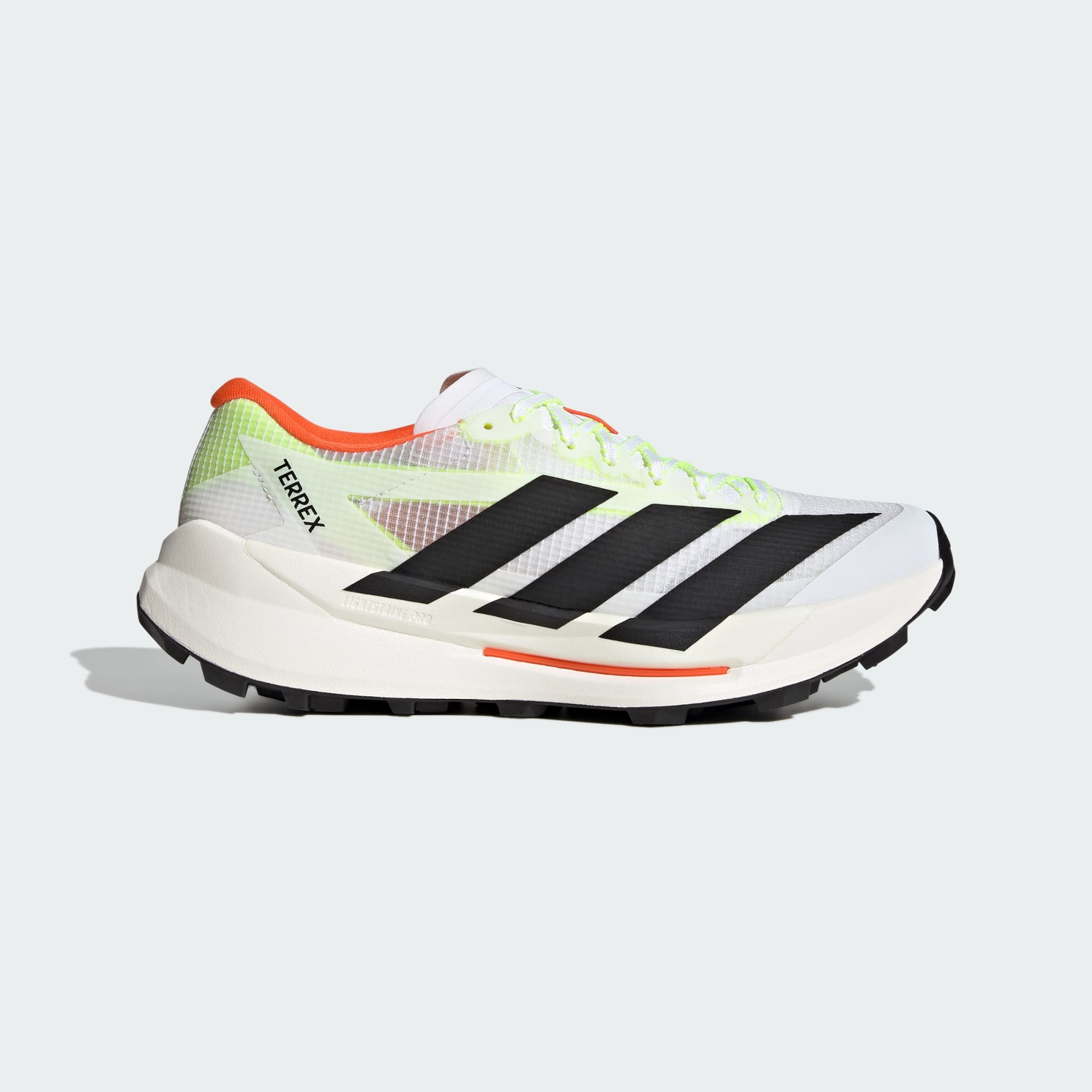 side view of adidas terrex agravic tt trail running shoe in white with coral and lime detail