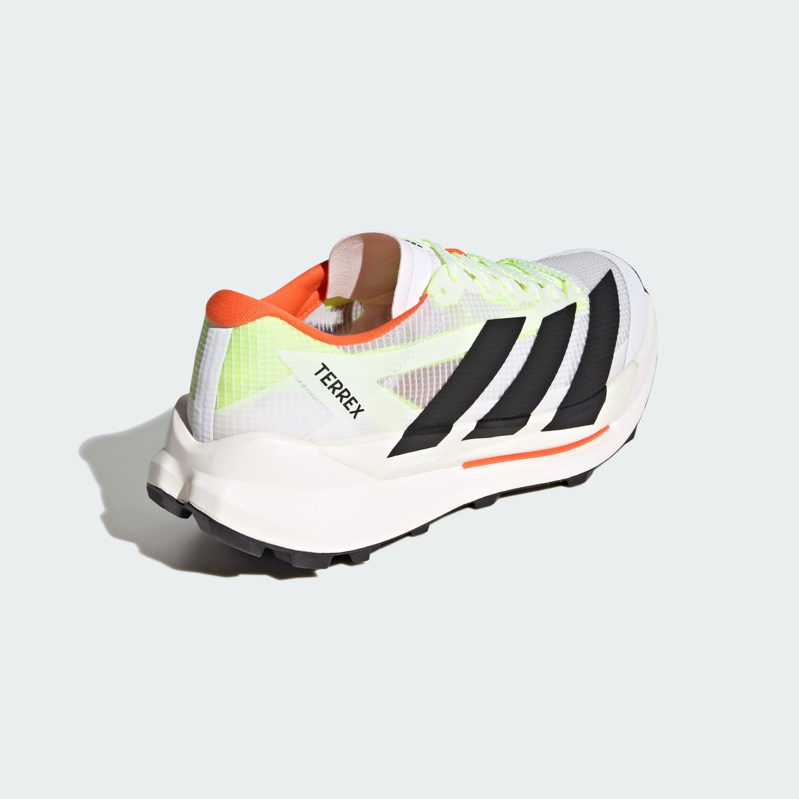 back view of adidas terrex agravic tt trail running shoe in white with coral and lime detail