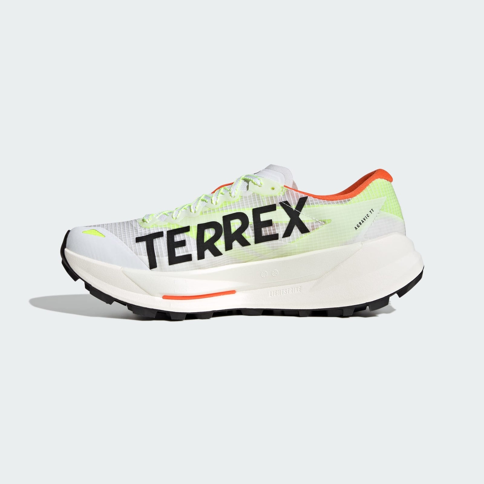 side view of adidas terrex agravic tt trail running shoe in white with coral and lime detail