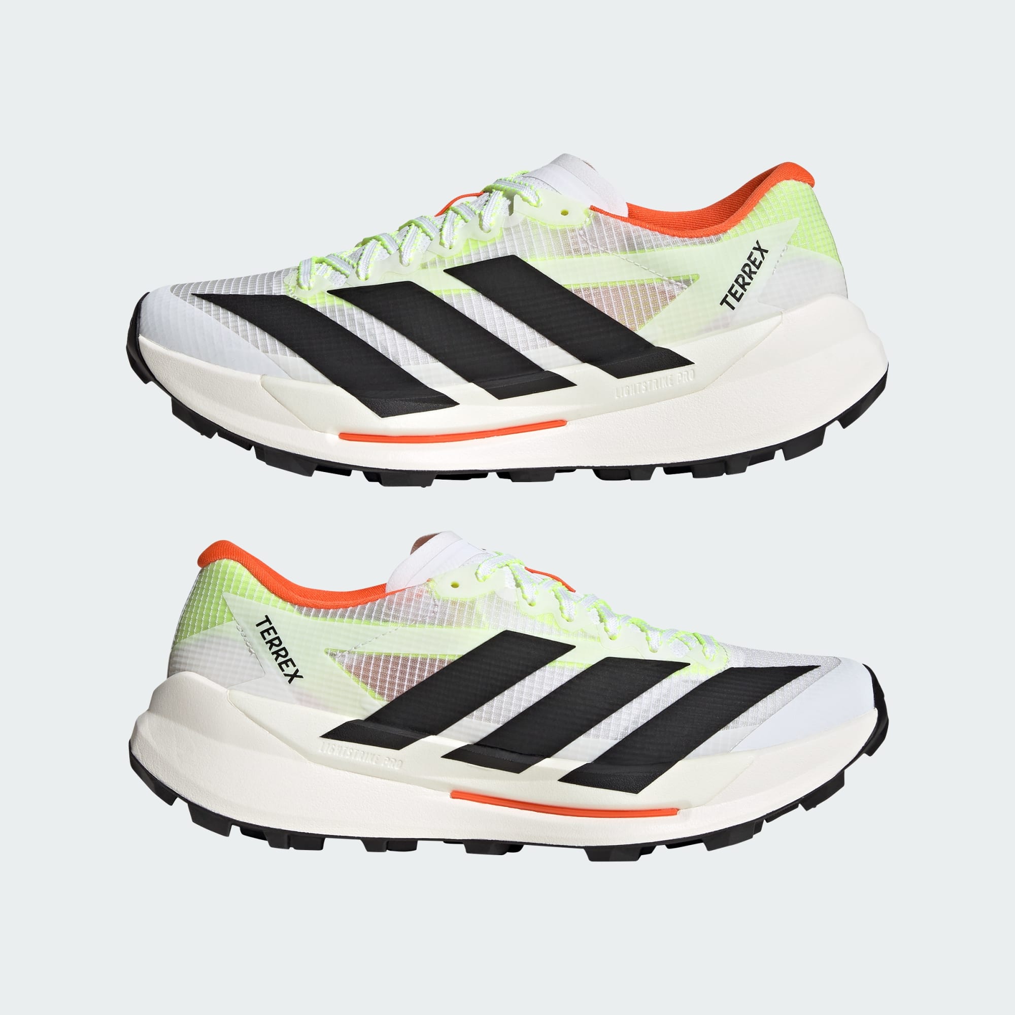 pair of adidas terrex agravic tt trail running shoe in white with coral and lime detail