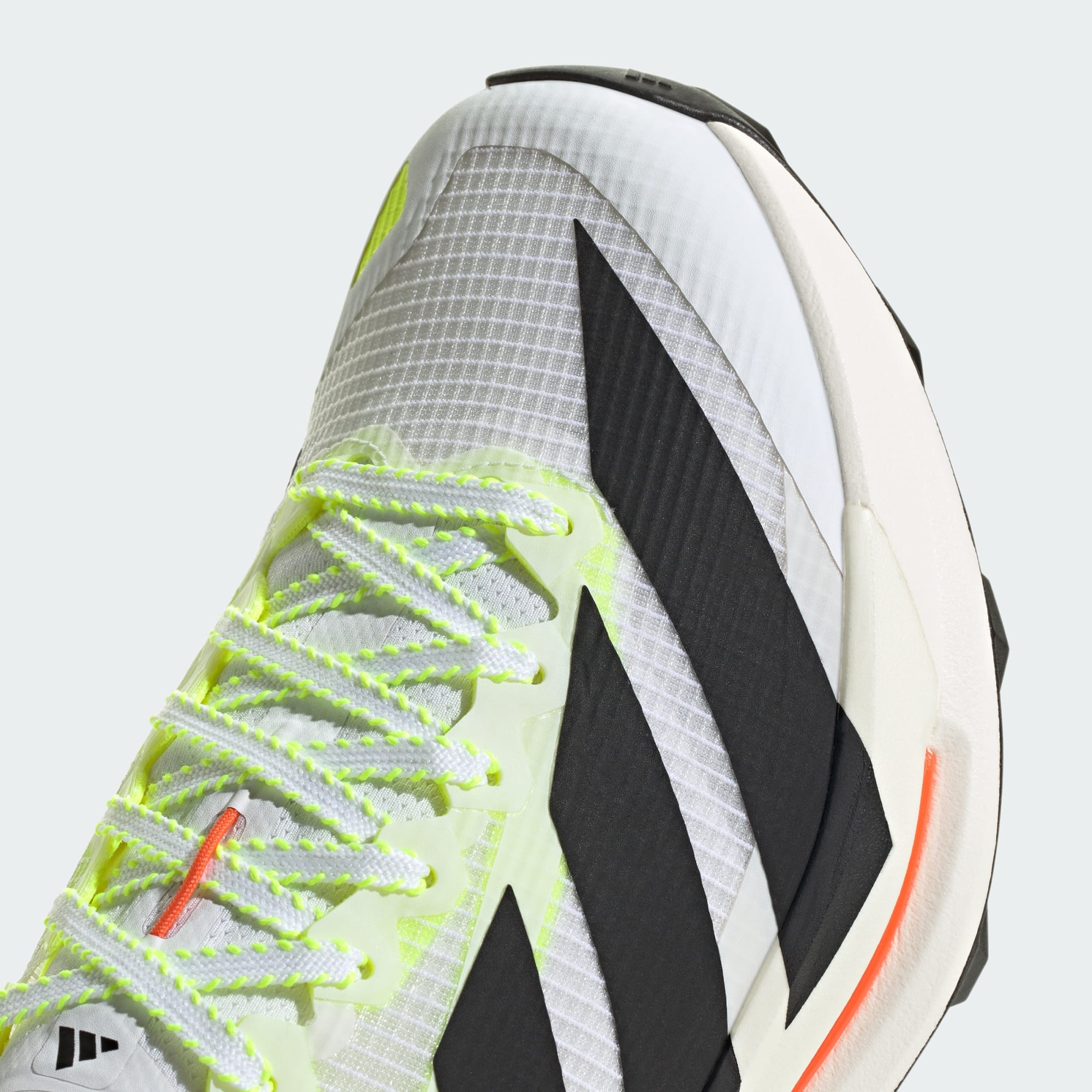 close up of adidas terrex agravic tt trail running shoe in white with coral and lime detail showing laces and toe box