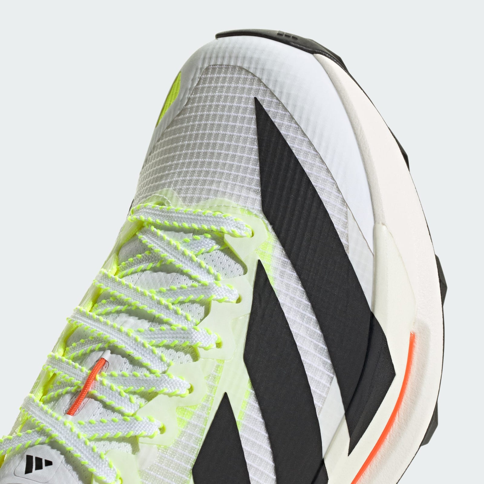 close up of adidas terrex agravic tt trail running shoe in white with coral and lime detail showing laces and toe box