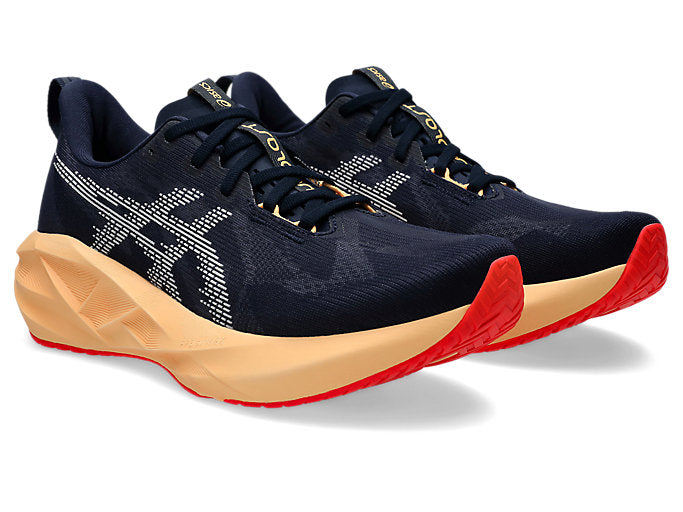 pair of asics novablast 5 navy running shoes for men with beige and red soles 