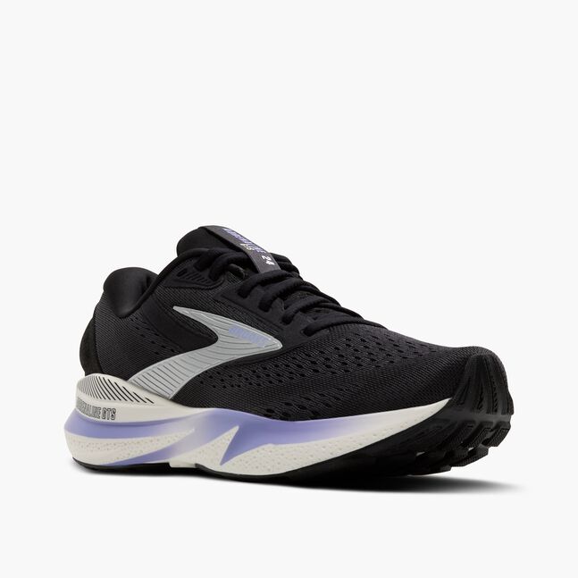 brooks adrenaline gts 24 for women, cushioned supportive running and walking shoe, black colour with silver logo white sole and purple details, side profile of shoe angled with toe closer