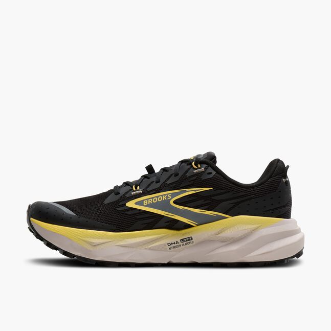 brooks cascadia 19 for men, trail running and walking shoe, black with white sole and yellow details, side profile of shoe