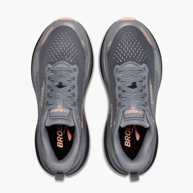brooks cascadia 20 for women, road to trail gravel running and walking shoe, dark grey and black with peach detail, top of shoes