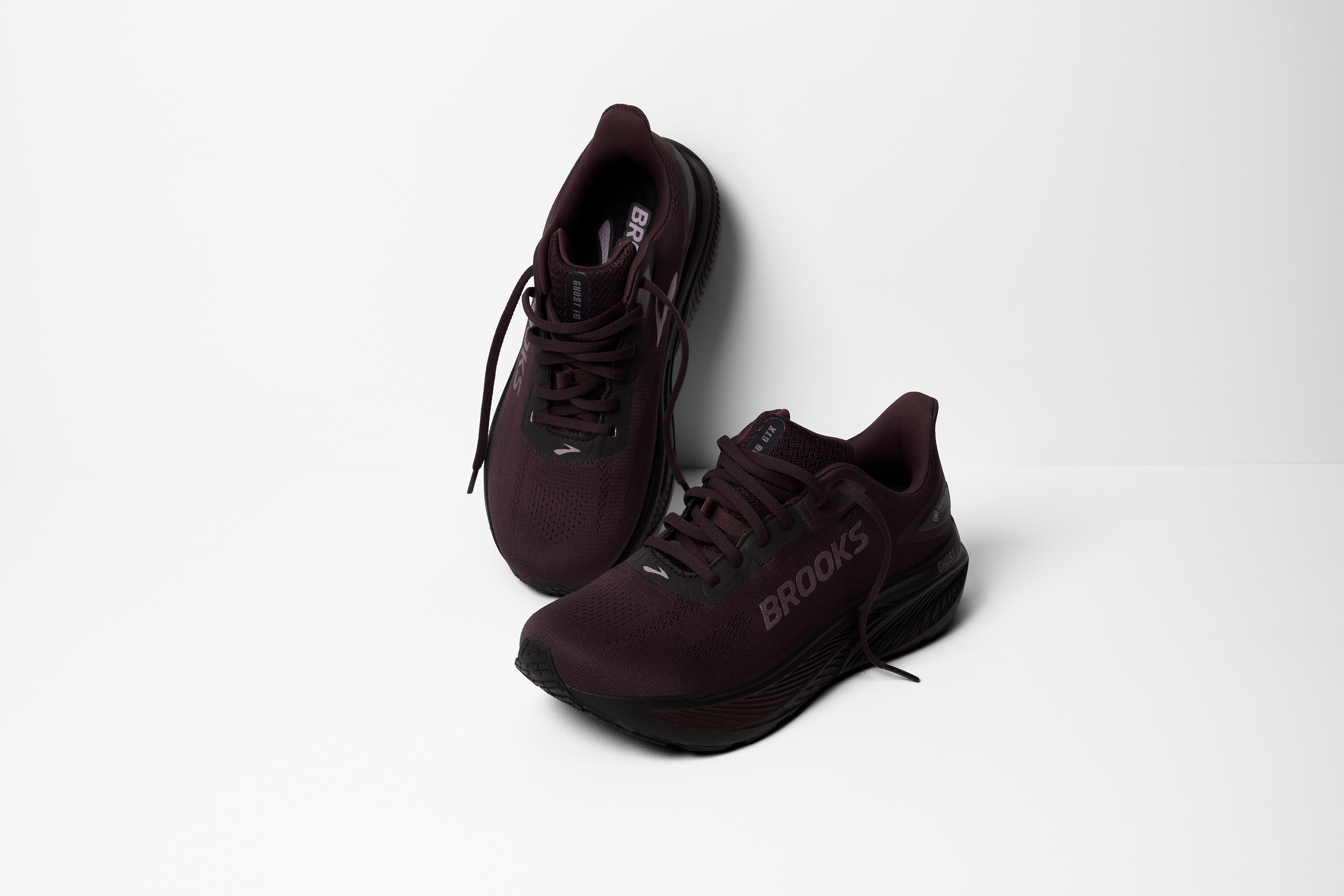 brooks ghost 18 gtx for women, waterproof everyday running and walking shoe, side profile of shoe, black with black sole, pair of shoes laces untied