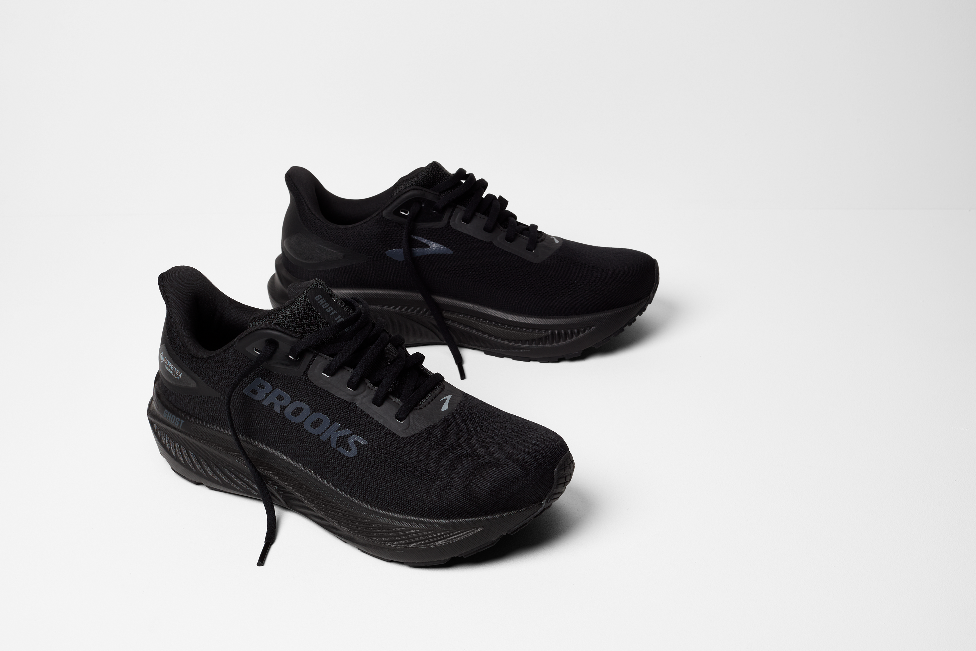 brooks ghost 18 gtx for women, waterproof everyday running and walking shoe, side profile of shoe, black with black sole, pair of shoes on white background 