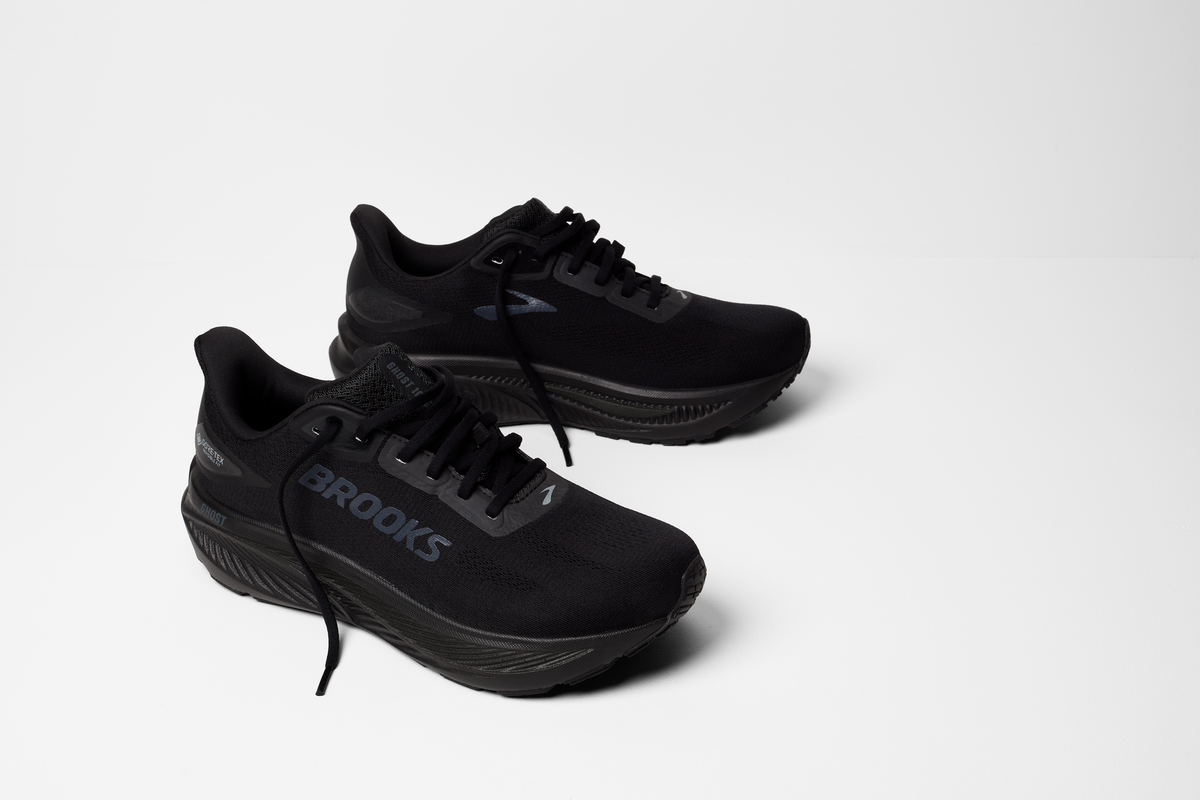 brooks ghost 18 gtx for women, waterproof everyday running and walking shoe, side profile of shoe, black with black sole, pair of shoes on white background 