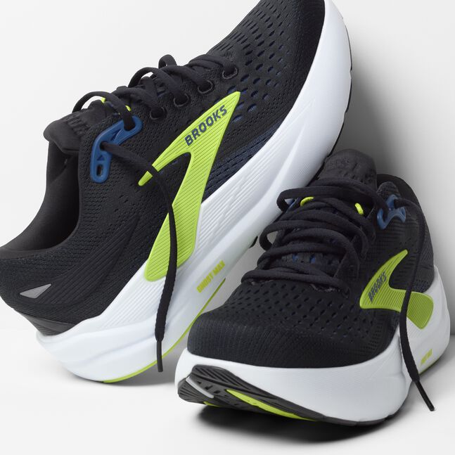 brooks ghost max 3 for men, maximum cushioned running and walking shoe, black with white sole and lime green details, pair of shoe with laces untied leaning on each other
