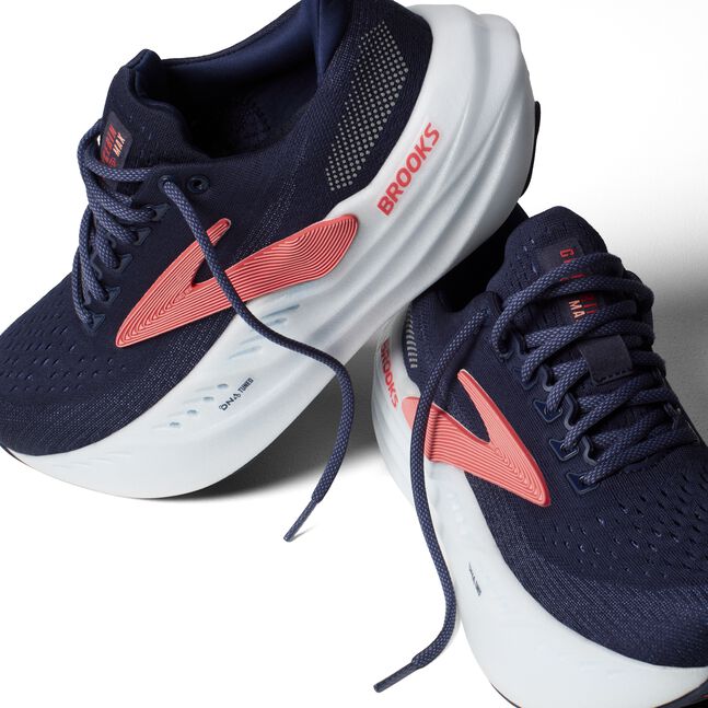 brooks glycerin max for women, maximum cushioning running shoe for recovery runs and long distances, navy colour with white sole and pink 'brooks' logo, pair of shoes with laces untied one shoe stacked on top of other