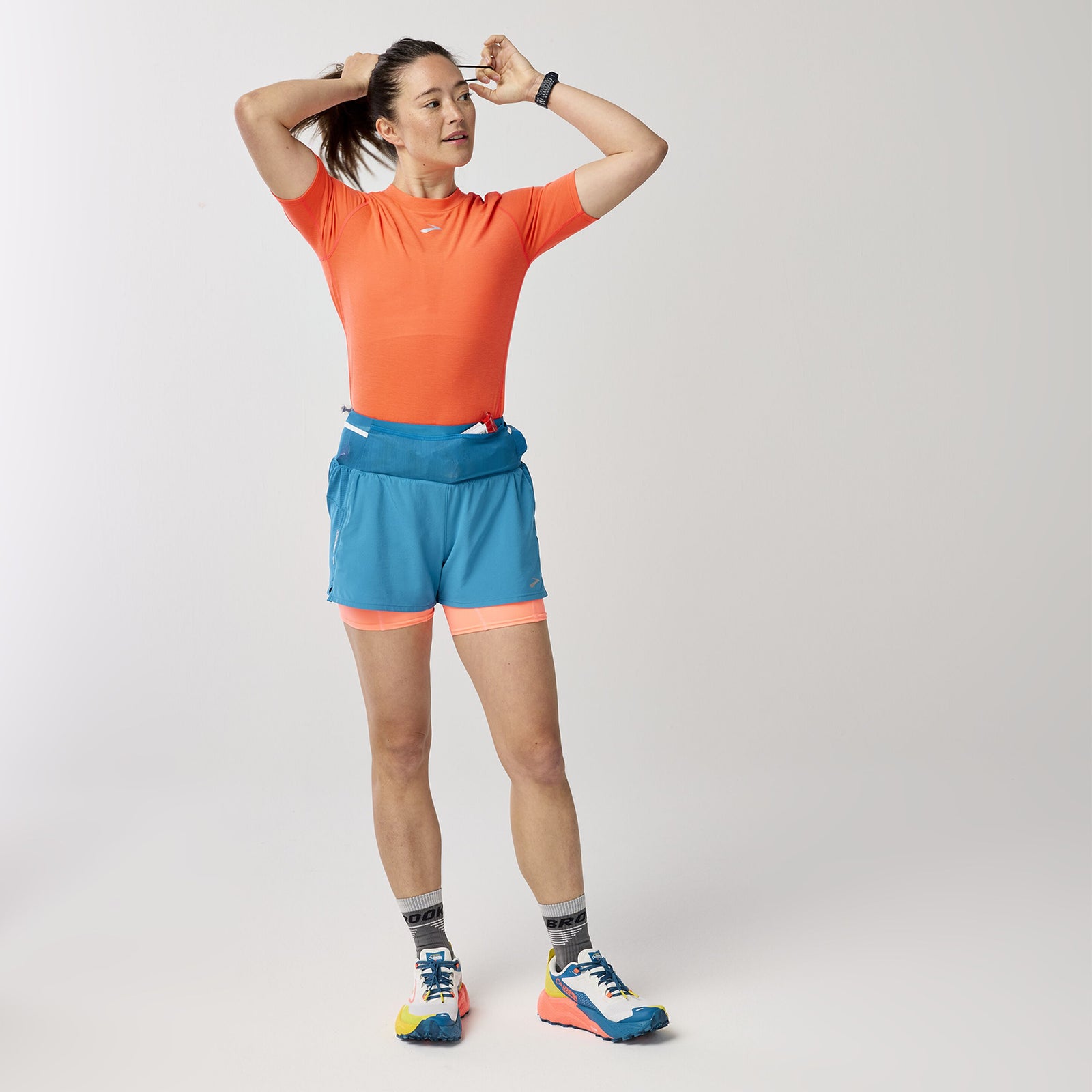 Brooks High Point Women's Trail Shorts with pockets and storage, blue and orange