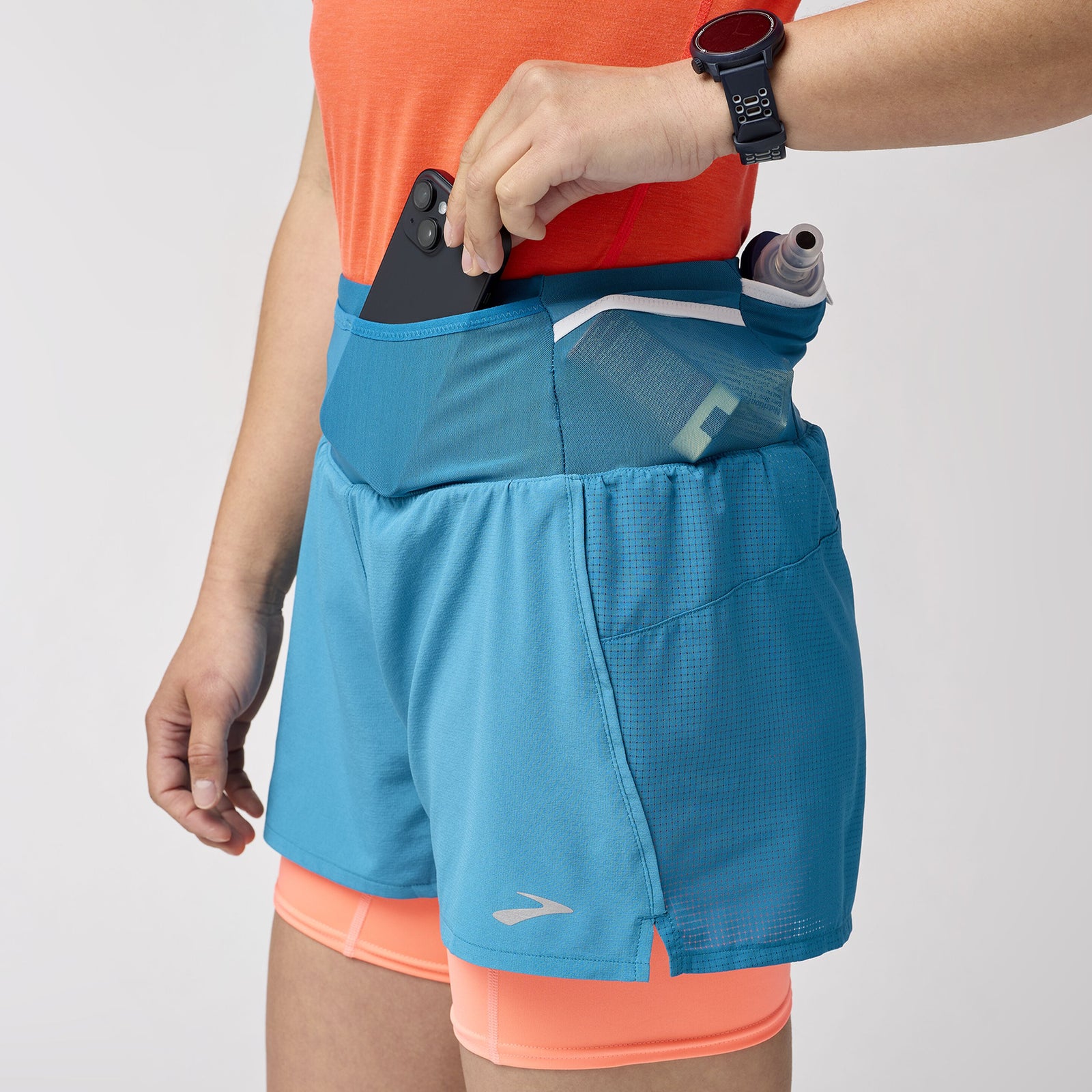 Brooks High Point Women's Trail Shorts with pockets and storage, blue and orange