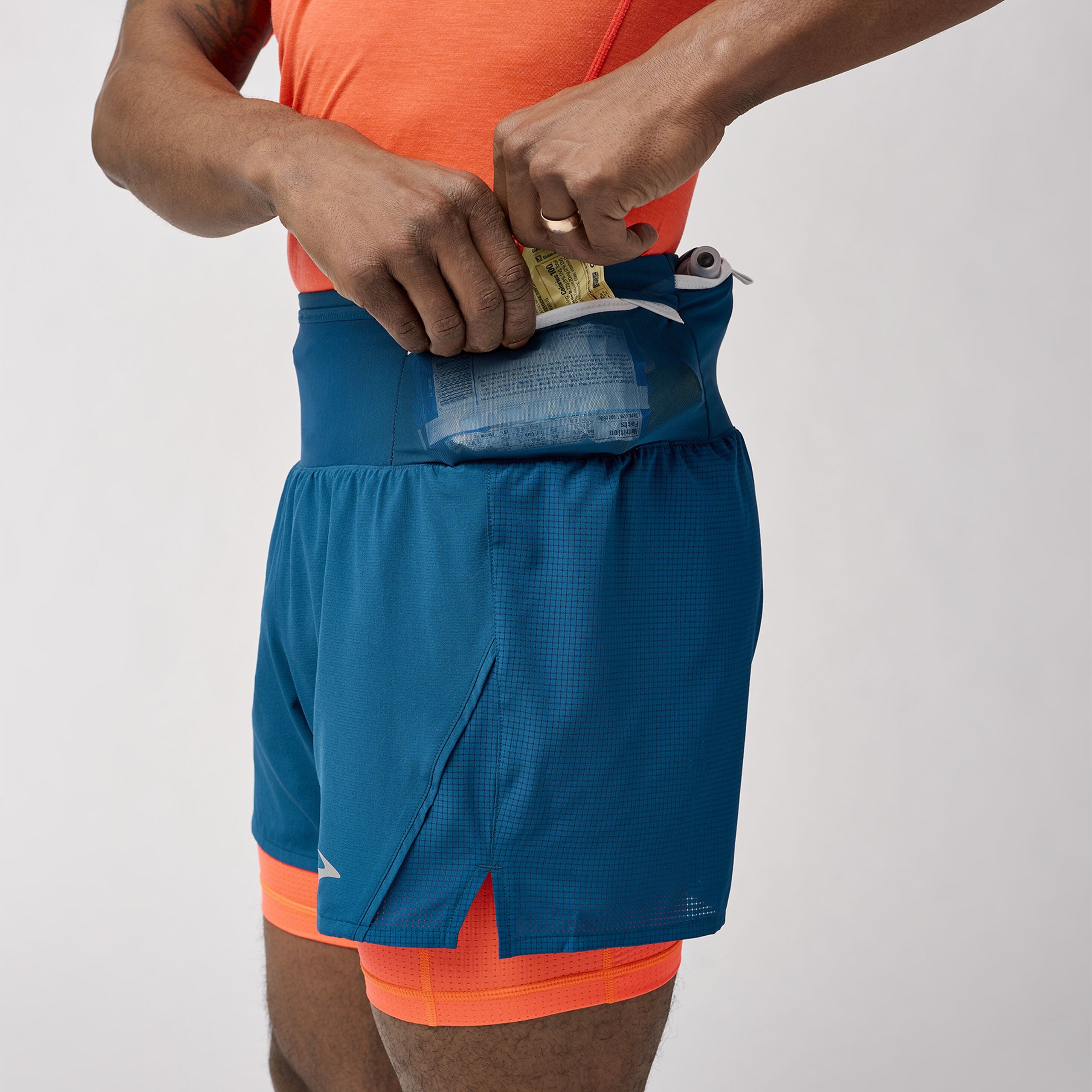 Brooks High Point 2in1 trail shorts for men with waist pockets designed to hold everything you need for your trail run