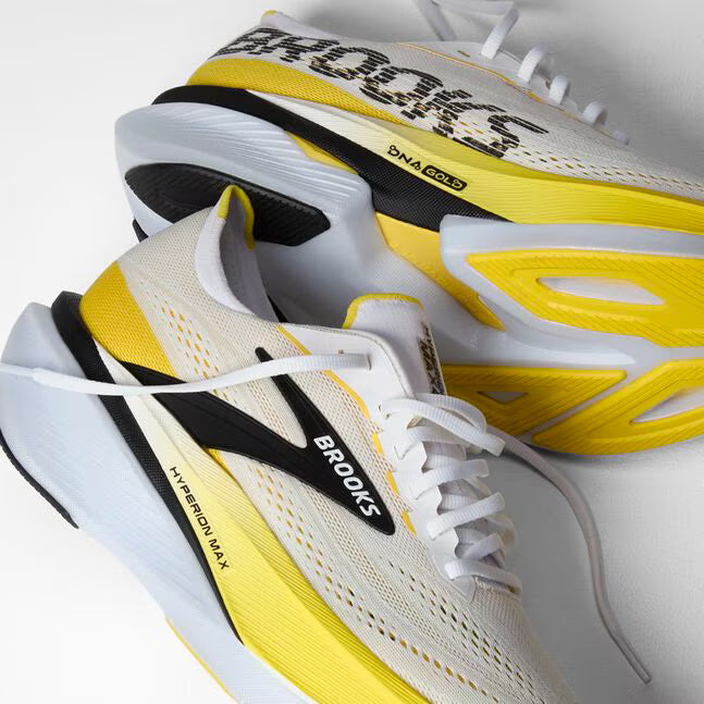 Side view of brooks hyperion max cushioning road running shoe in a white and yellow colour