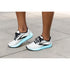woman wearing brooks hyperion tempo in white and black with blue sole