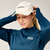 brooks journey reflective hat, lightweight sweat wicking reflective running hat, white colour with reflective silver logo, woman wearing running hat