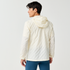 Man wearing Brooks Canopy Reflective Run Jacket, white colour, reflective details, showing the back with hood