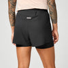 brooks cascadia 2-in-1 short, lightweight running short with pockets for women, black colour with white brooks logo, back view of woman wearing brooks shorts on a white background