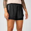 brooks cascadia 2-in-1 short, lightweight running short with pockets for women, black colour with white brooks logo, view of woman wearing brooks shorts on a white background