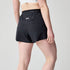 back profile of woman wearing brooks cascadia running short, lightweight women's trail-running shorts, black with white logo